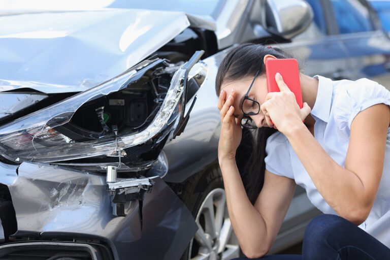 Driver after a fender bender in Santa Rosa with front-end damage that may require steering, tire, and wheel alignment inspection